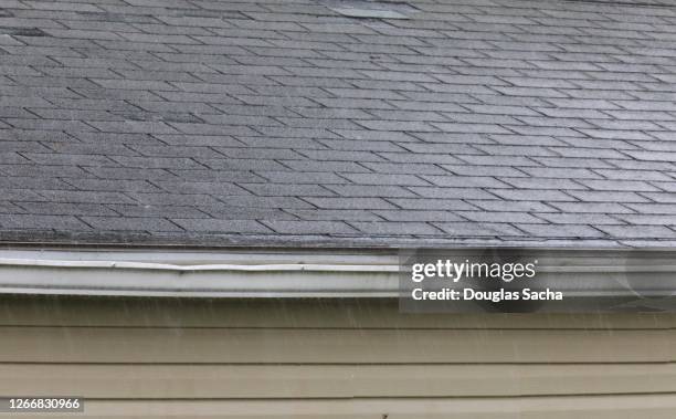 rain shower on a roof and gutter - rinnstein stock-fotos und bilder