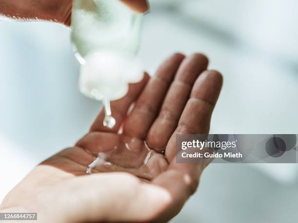 using hand washing gel doing disinfection. - gel pour les cheveux photos et images de collection