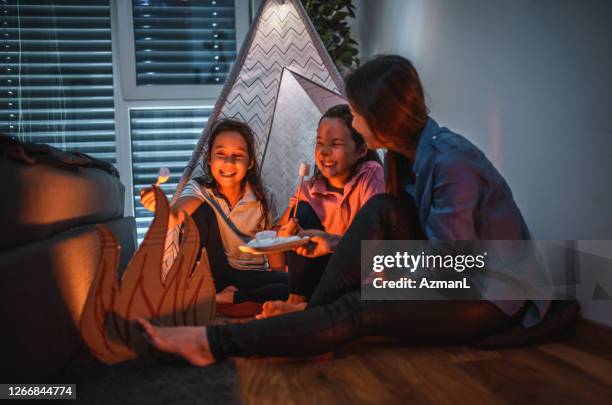 mother and daughters camping indoors due to quarantine - indoor camping stock pictures, royalty-free photos & images