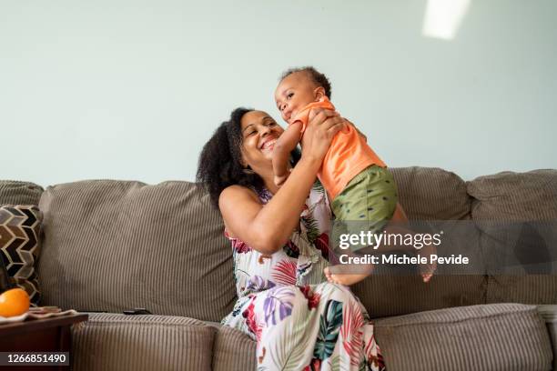 black mother and son having a good time together - young family at home stock pictures, royalty-free photos & images