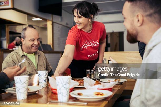 waitress clearing plates from table at restuarant - servitris bildbanksfoton och bilder