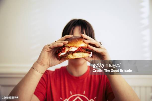 young woman holding a large sandwich - big sandwich stock pictures, royalty-free photos & images