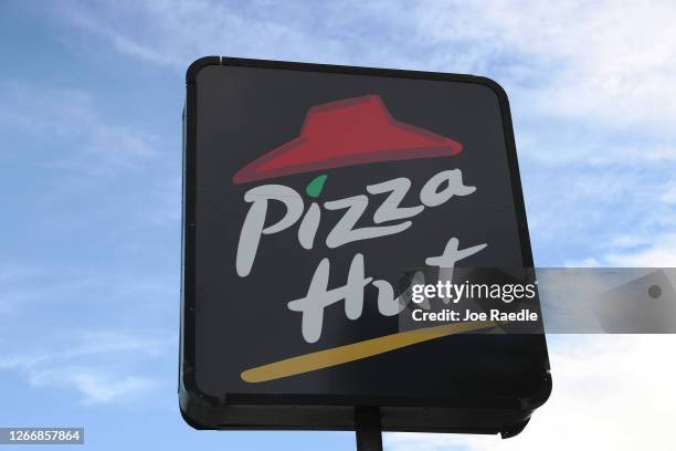 Sign is seen at a Pizza Hut restaurant on August 17, 2020 in Miami, Florida. NPC International announced it had reached an agreement with Yum!...