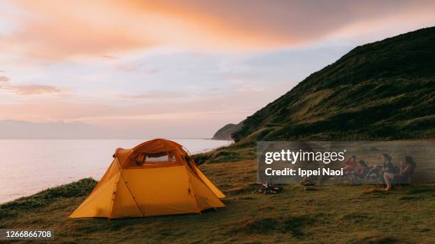 family camping by the sea at sunset - japanese tents stock pictures, royalty-free photos & images