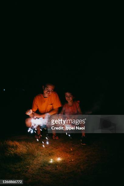 children playing with sparklers at night - japan 12 years girl stock pictures, royalty-free photos & images