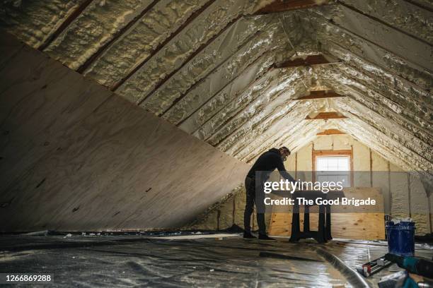 mature man renovating home interior - attic stock pictures, royalty-free photos & images