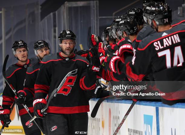 Justin Williams of the Carolina Hurricanes celebrates scoring a goal against the Boston Bruins with teammates during the first period of Game Four of...