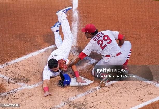 Alex Reyes of the St. Louis Cardinals tags out Kyle Schwarber of the Chicago Cubs at the plate during the first inning of game two of a doubleheader...