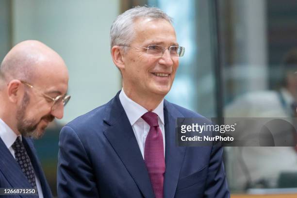 Jens Stoltenberg the Secretary General of NATO as seen smiling next to Charles Michel President of the European Council at the Tour de Table - Round...