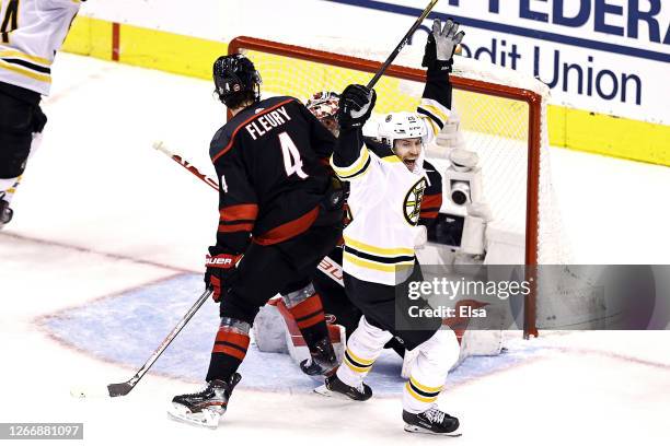 Par Lindholm of the Boston Bruins celebrates a goal by his teammate Connor Clifton , against the Carolina Hurricanes during the third period in Game...