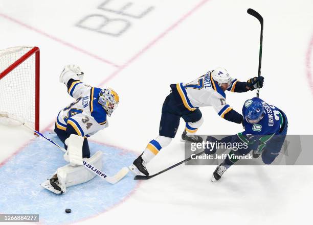 Jake Allen and Jaden Schwartz of the St. Louis Blues defend against Loui Eriksson of the Vancouver Canucks during the first period in Game Four of...