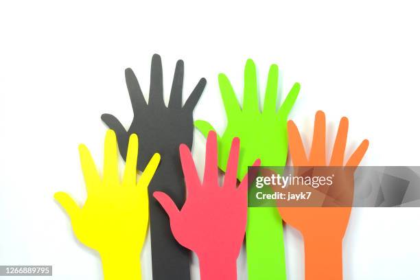 raising hands - volunteer hands colorful stock pictures, royalty-free photos & images