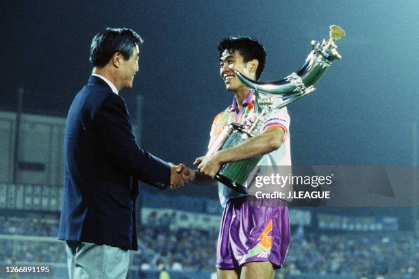 Hajime Moriyasu of Sanfrecce Hiroshima shakes hands with the J.League Chairman Saburo Kawabuchi as they celebrate the Suntory Series champions...