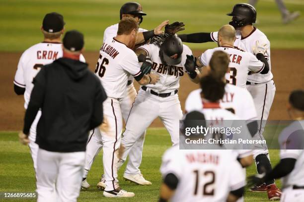 David Peralta of the Arizona Diamondbacks is congratulated by teammates after a walk-off RBI single against the Oakland Athletics during the ninth...