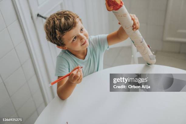 boy building a rocket at home - model rocket stock pictures, royalty-free photos & images