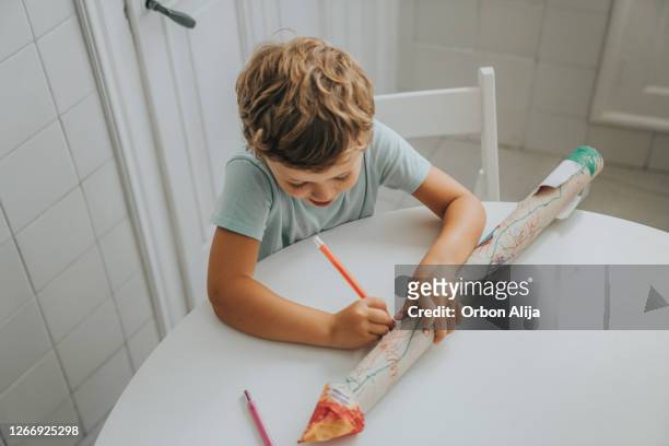 boy building a rocket at home - model rocket stock pictures, royalty-free photos & images