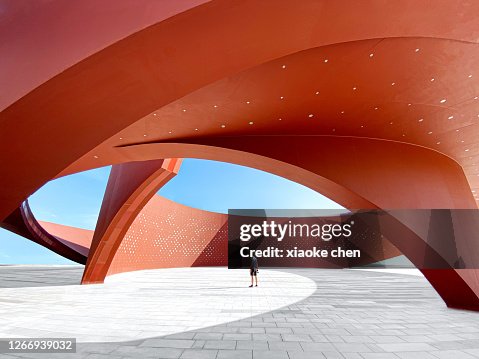 A person in a red curved abstract architectural space, 3D rendering A person in a red curved abstract architectural space, 3D rendering