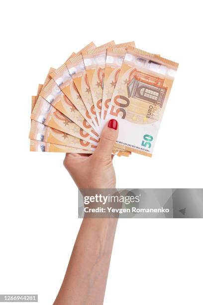 woman's hand holds 50 euro bills, isolated on white background - 50 euro stock pictures, royalty-free photos & images