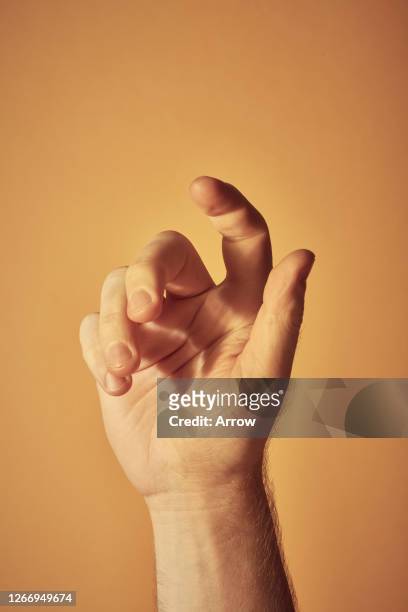young man on yellow background - human finger 個照片及圖片檔