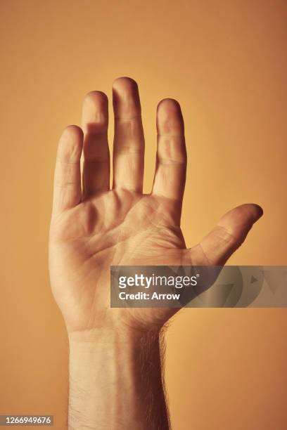 young man on yellow background - hand waving stock pictures, royalty-free photos & images
