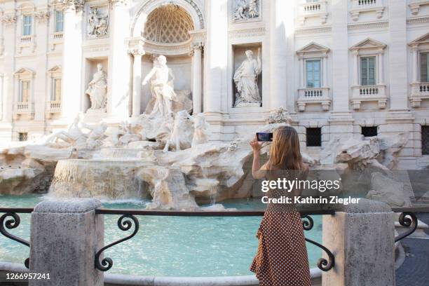 woman taking pictures of trevi fountain in rome, italy - rome italy stock pictures, royalty-free photos & images