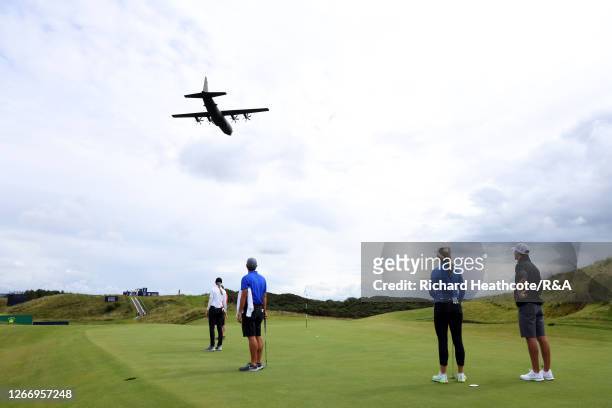 Nelly Korda and Jessica Korda of The United States of America look on as a Military plane flys over the course during a practice round ahead of the...