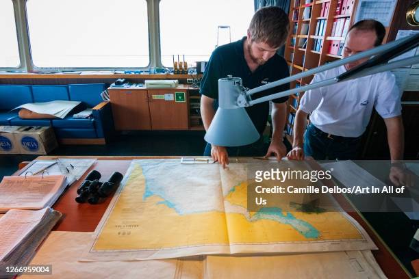 Sailors discussing the trajectory with a map on Janvier 11, 2017 in , Gulf of Aden, British Indian Ocean Territory.