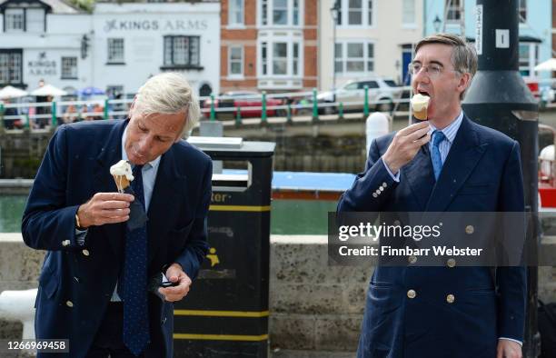 For North East Somerset, Jacob Rees-Mogg eats an ice-cream from Boho Gelato ice cream parlour with Richard Drax MP at the harbourside on August 18,...