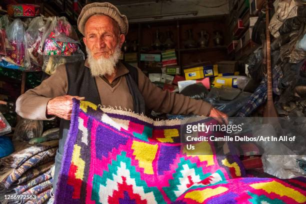 Shopkeeper wearing an Afghan felt beret and a beard on Mai 25, 2016 in Chitral, Khyber Pakhtunkhwa, Pakistan.