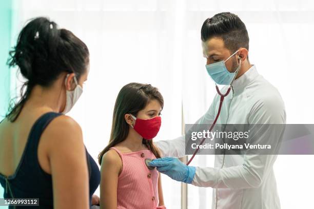 mother and daughter at medical consultation - children's hospital stock pictures, royalty-free photos & images