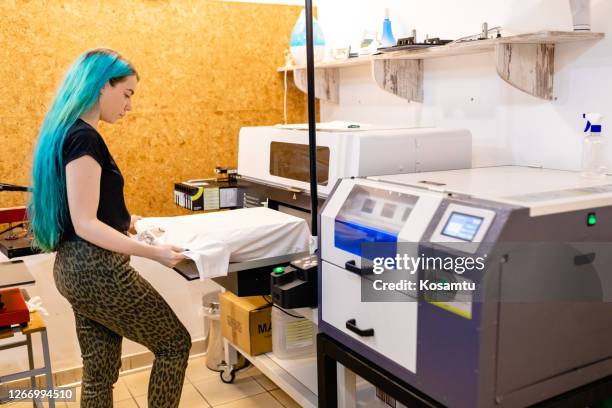 after receving order diligent female worker preparing t-shirt on a silk machine - t shirt printing stock pictures, royalty-free photos & images
