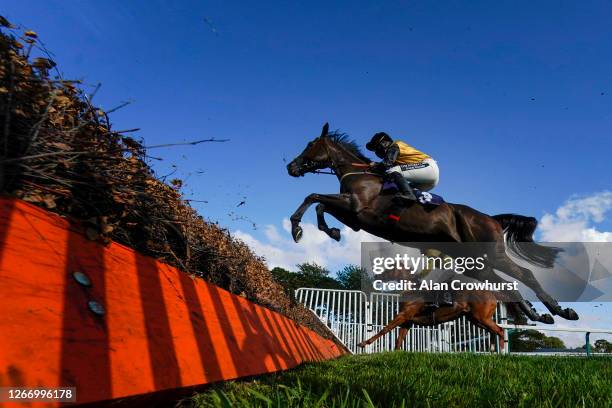 General view as runners clear a fence at Fontwell Park Racecourse on August 18, 2020 in Fontwell, England. Owners are allowed to attend if they have...