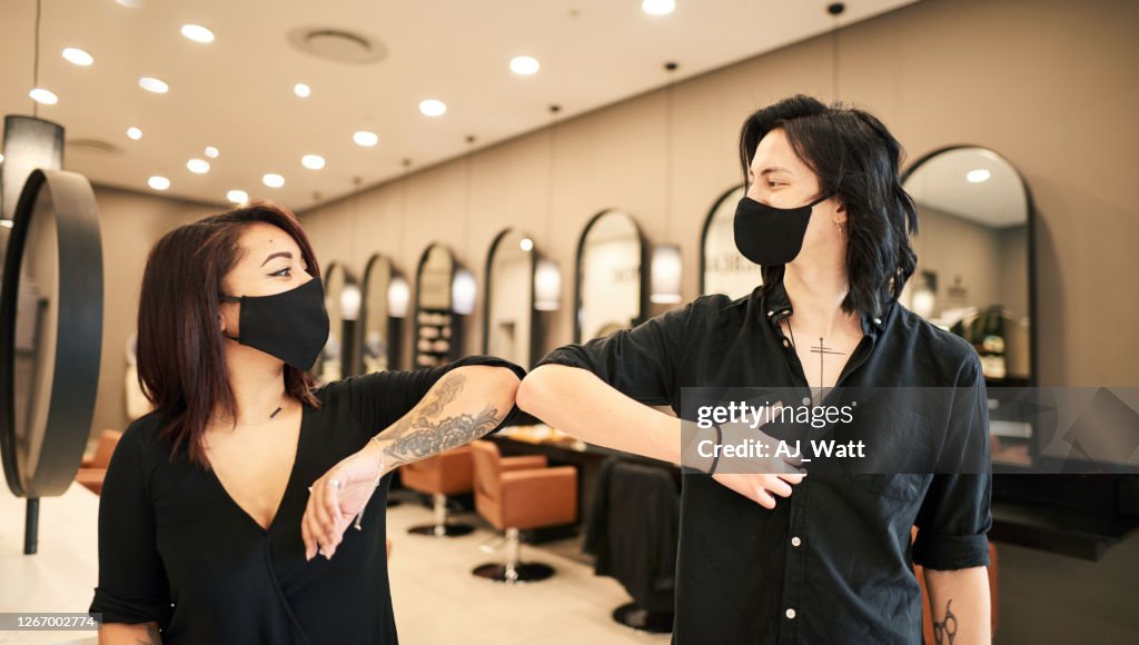 Business people greeting during COVID-19 pandemic, elbow bump