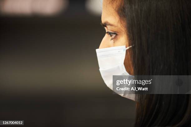 profile of a woman wearing protective mask - patient profile stock pictures, royalty-free photos & images