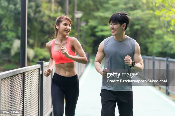 friends jogging in public park - asian six pack ストックフォトと画像