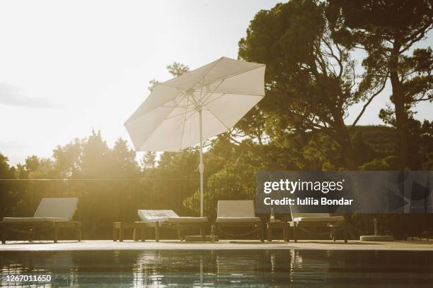 luxury pool with sunbeds - sun deck stock pictures, royalty-free photos & images