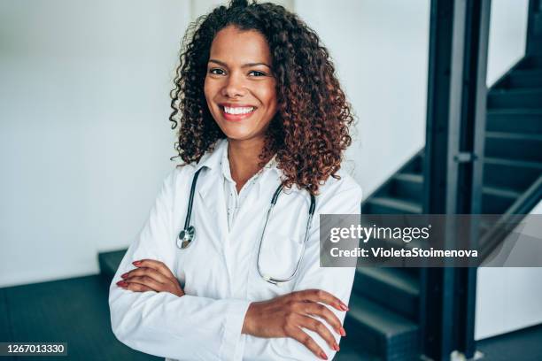 portrait of a confident young female doctor at work. - black female doctor stock pictures, royalty-free photos & images