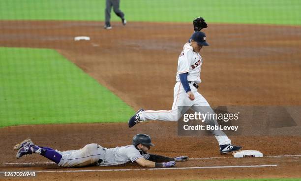 Zack Greinke of the Houston Astros beats Garrett Hampson of the Colorado Rockies to the base in the sixth inning at Minute Maid Park on August 18,...