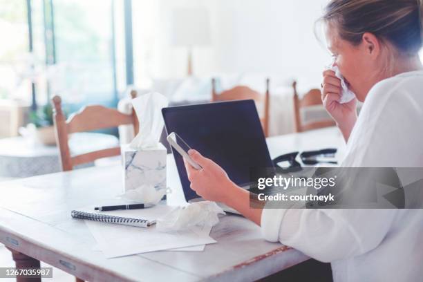 frau mit einer erkältung oder grippe oder allergie arbeiten zu hause. - krankenstand stock-fotos und bilder