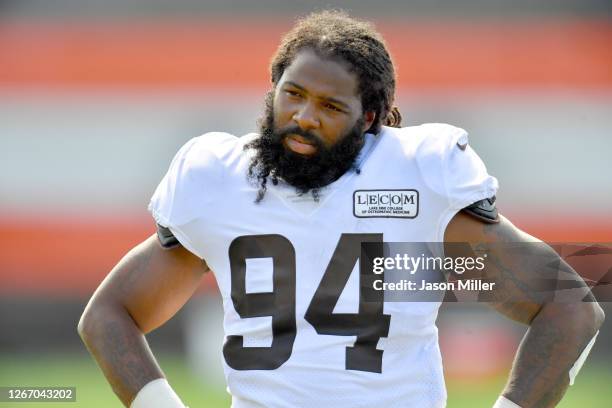 Defensive end Adrian Clayborn of the Cleveland Browns listens to a teammate during NFL training camp on August 18, 2020 at the Browns training...