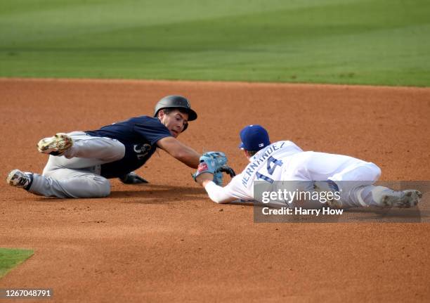 Dylan Moore of the Seattle Mariners is tagged out at second base by Enrique Hernandez of the Los Angeles Dodgers, after an over slide attempting to...