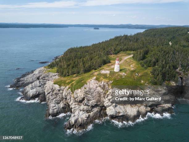 high angle view of musquash head lighhouse on the bay of fundy near saint john, new brunswick, canada - bay of fundy stock pictures, royalty-free photos & images