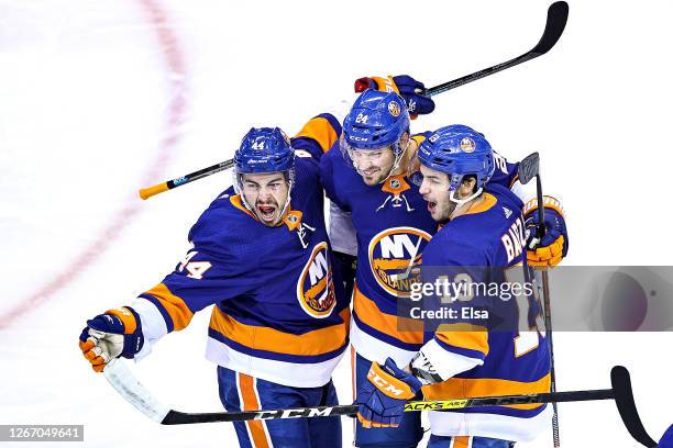 Jean-Gabriel Pageau of the New York Islanders is congratulated by his teammates, Scott Mayfield and Mathew Barzal after scoring a goal at 3:50...