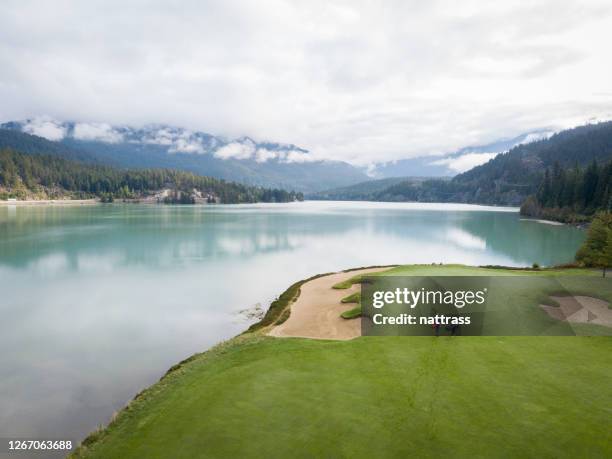 dos golfistas se dirigen hacia el green - campo golf fotografías e imágenes de stock