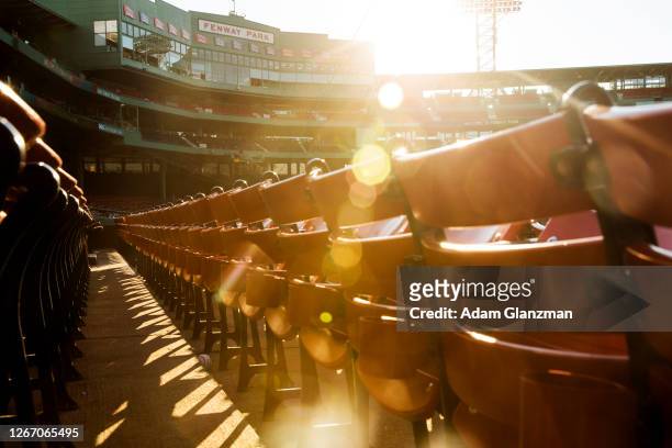The sun sets over the Fenway Park facade before a game between the Boston Red Sox and the Philadelphia Phillies at Fenway Park on August 18, 2020 in...
