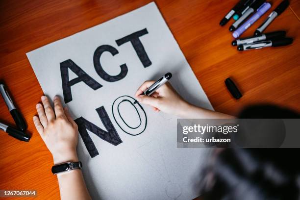 woman making a protest banner - justice reform stock pictures, royalty-free photos & images