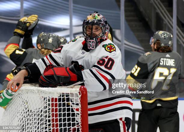 Goaltender Corey Crawford of the Chicago Blackhawks reacts as the Vegas Golden Knights celebrate a goal by Mark Stone during the second period of...