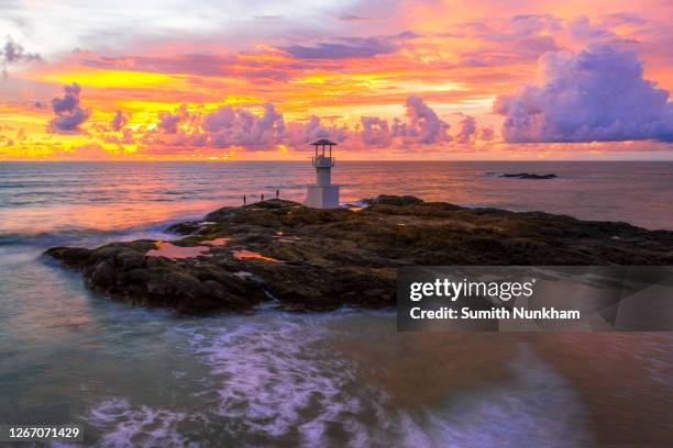 khao lak tower lighthouse beacon withe tower on the rock of coast. with checking tsunami waves on the beach with the sunset time phang nga, thailand - khao lak stock pictures, royalty-free photos & images