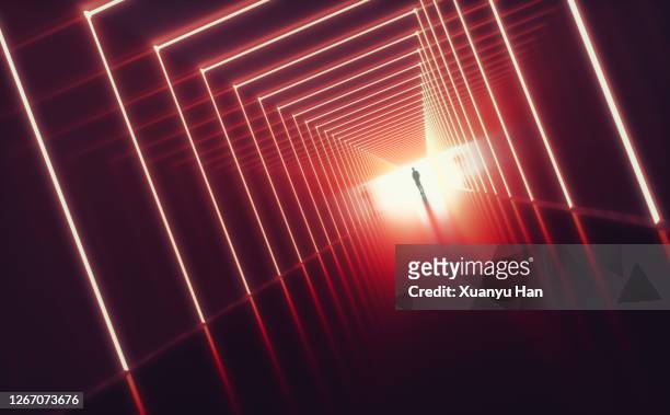 man standing in empty futuristic passage - man silhouette back lit stock pictures, royalty-free photos & images