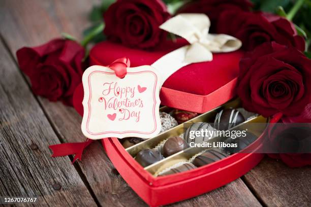 valentine's day box of chocolates and red roses - valentines day stock pictures, royalty-free photos & images